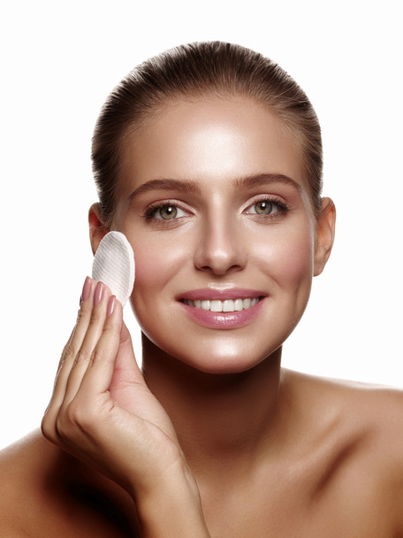 Girl does daily skincare using a cotton pad - Photo, image