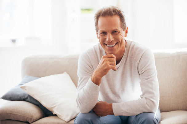 mature man sitting on the couch at home - Photo, Image