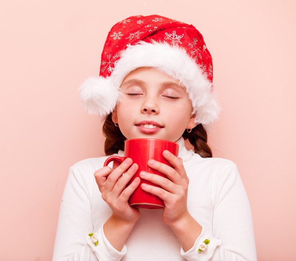 girl with cup in Santa Claus hat - Foto, immagini