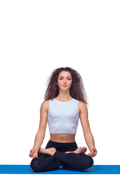 Studio shot of a young fit woman doing yoga exercises. - Photo, image