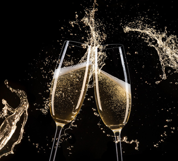 Glasses of champagne with splash, celebration theme. - Photo, Image