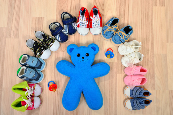 Baby shoes arranged in a line. - Фото, изображение
