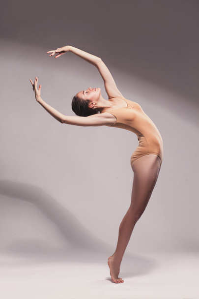 young beautiful dancer in beige swimsuit posing - Zdjęcie, obraz