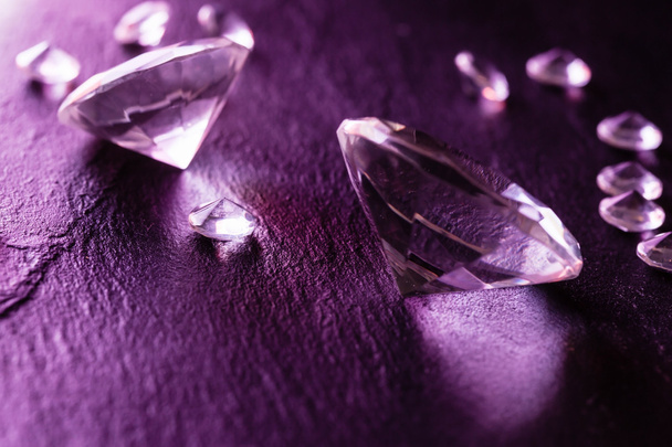 Different diamonds on purple background - Фото, изображение