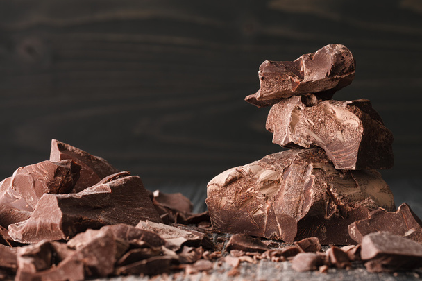 Chocolate pieces on a dark backround - Фото, изображение