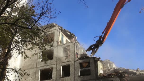 Hydraulic crusher excavator machinery working on demolition old house.Moscow, Russia - Video