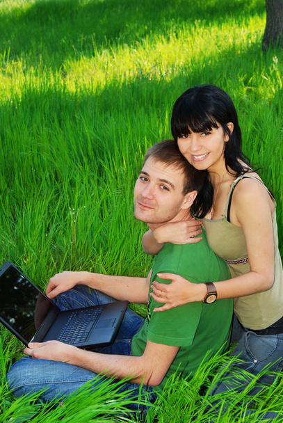Young couple with laptop outdoor - Fotó, kép