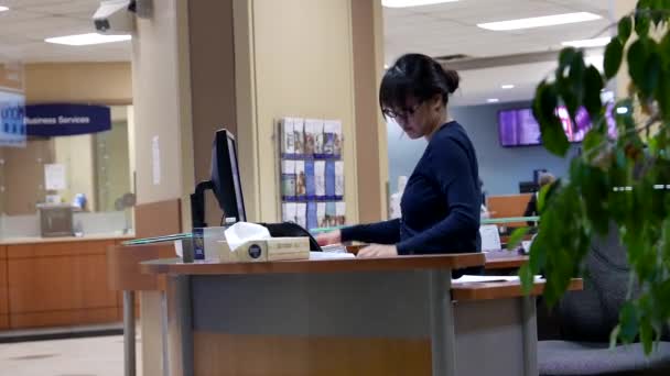 One side of receptionist dealing of customer data inside Royal bank - Footage, Video