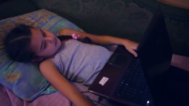 girl teen playing laptop lying on sofa lifestyle internet search  computer game - Záběry, video