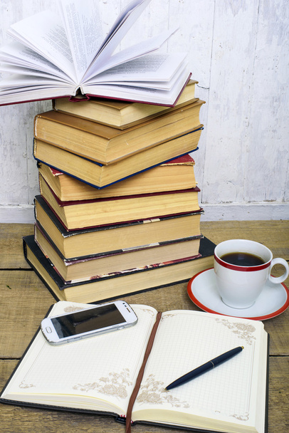 books, notepad, cellphone and coffee cup on wooden background. Education concept - Foto, Imagen