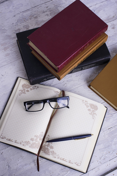 vintage books, notebook, pen and glasses on white wooden background - Foto, Imagen