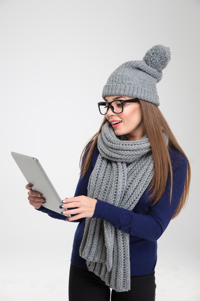 Mulher em pano de inverno usando computador tablet
 - Foto, Imagem