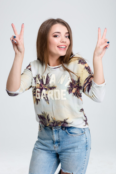 Smiling woman showing two fingers sign - Foto, Bild