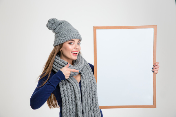 Happy woman pointing finger on blank board - Zdjęcie, obraz