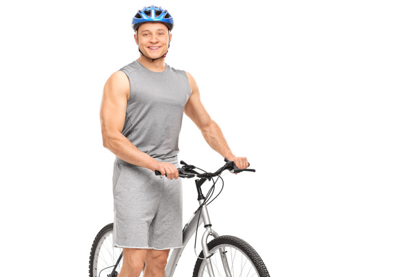 biker posing next to his bicycle - Photo, Image