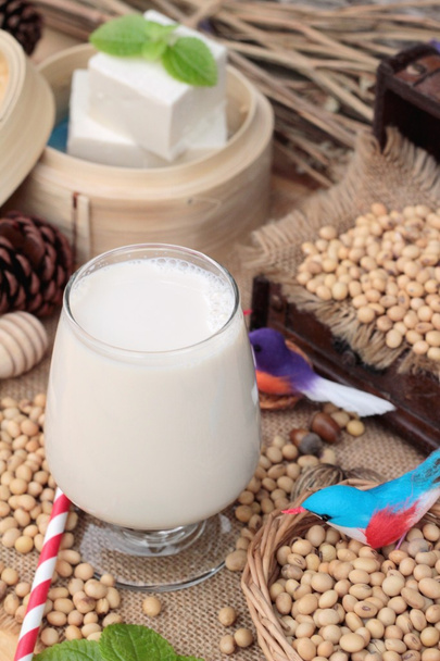Soy milk and soybeans on wood background. - Photo, Image