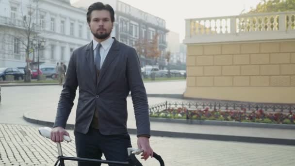university male student standing in the street with his bicycle - Záběry, video