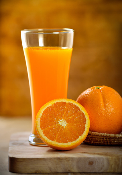 Orange juice glass and fresh oranges on wood - Photo, Image