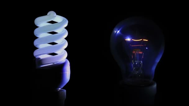 Traditional light bulb and energy saving light bulb - Footage, Video