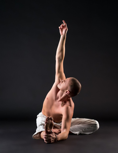 Image of bare-chested man doing yoga in studio - Photo, Image