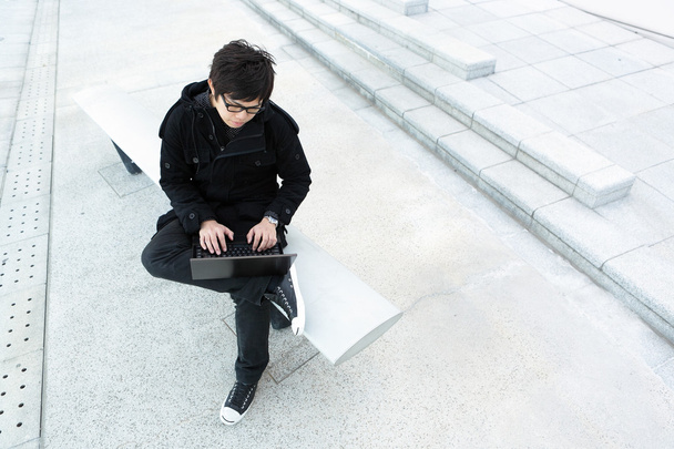 Man using computer outdoor - Fotó, kép