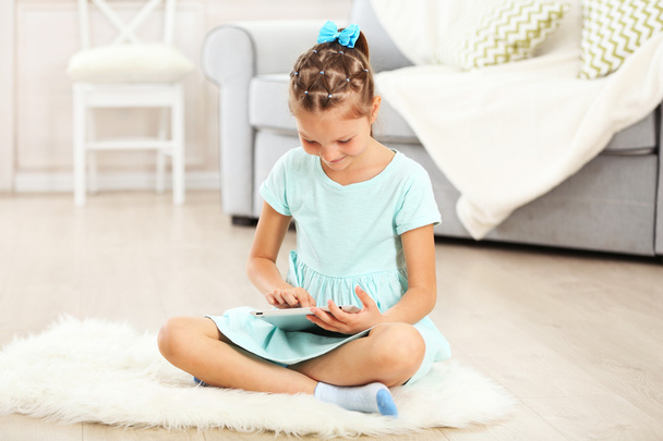 Little cute girl with digital tablet  - Foto, Imagen