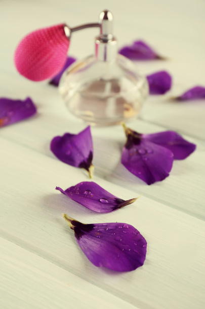 Bottle of perfume and flowers petals - Fotó, kép