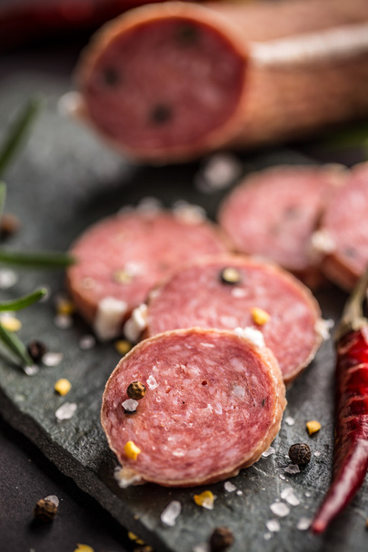 Salami with pepper on black - Photo, image