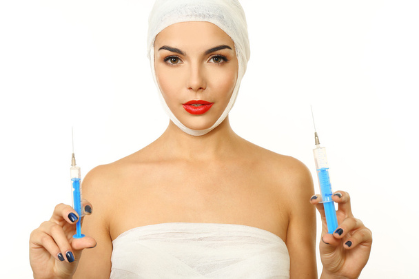 woman with a gauze bandage holding syringe - Photo, Image