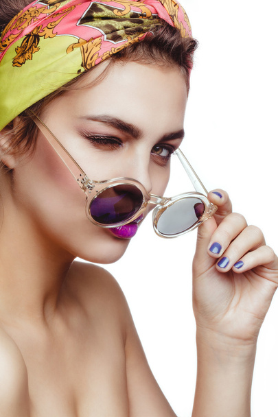 Beautiful charming attractive brunette woman wearing scarf on her head and sunglasses, purple lips. - Фото, зображення