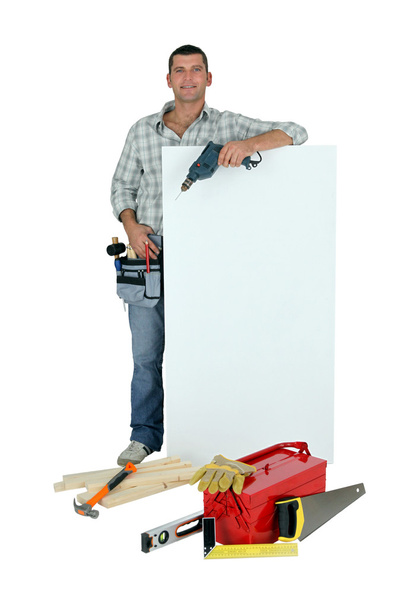 Handyman with tools and message board - Zdjęcie, obraz