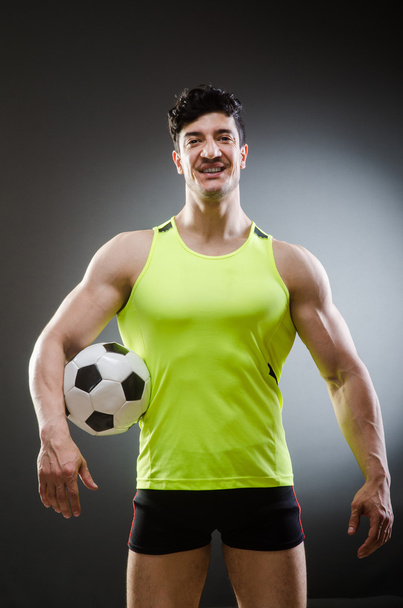 Muscular man with football ball - Foto, afbeelding