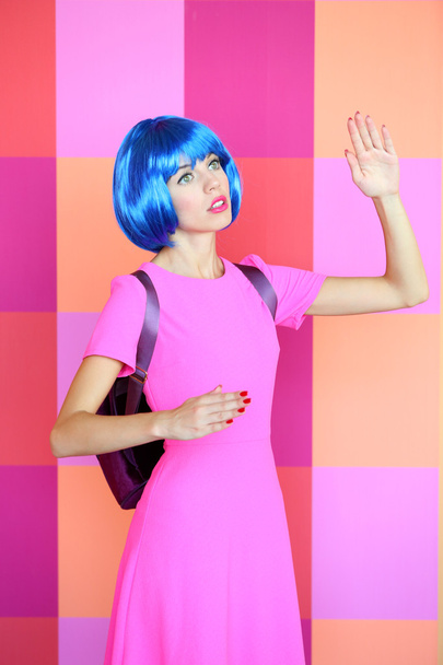 Young woman in dress posing like doll on bright wall background - Zdjęcie, obraz
