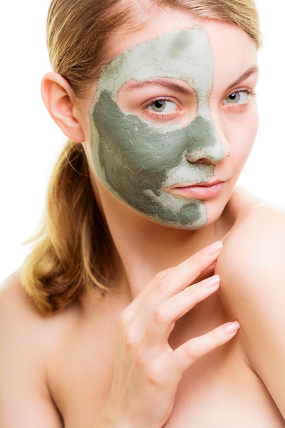 Woman in clay mud mask on face isolated on white. - 写真・画像