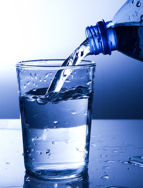 Pouring fresh water into a glass - Zdjęcie, obraz