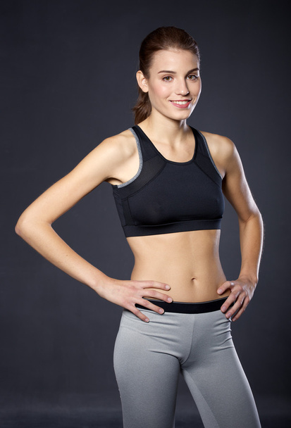 Portrait athletic girl on a black background - Photo, Image