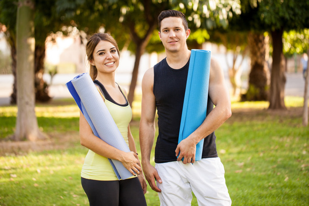 couple holding exercise mats - Photo, Image