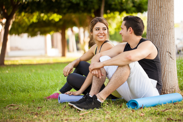 couple with exercise mats sitting - Photo, Image