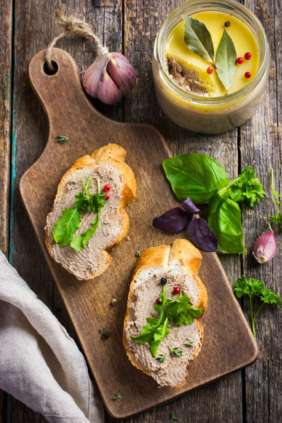 bread with chicken liver pate on wooden cutting board - Photo, Image