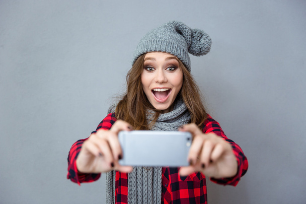Cheerful woman doing photo on smartphone - Foto, imagen