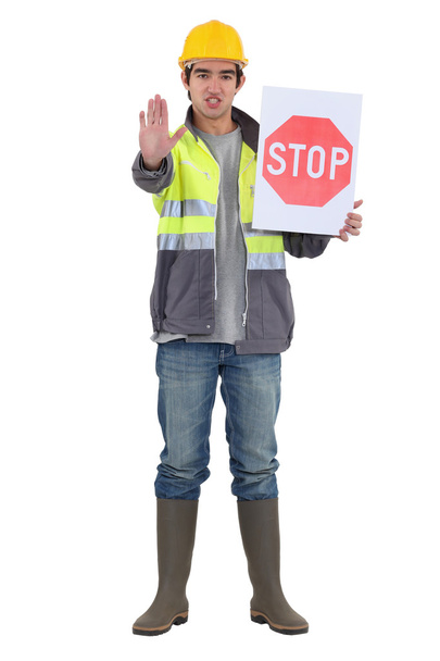 Craftsman holding a stop sign - Foto, Imagen