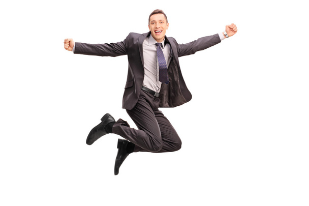 Overjoyed businessman jumping and gesturing happiness - Φωτογραφία, εικόνα
