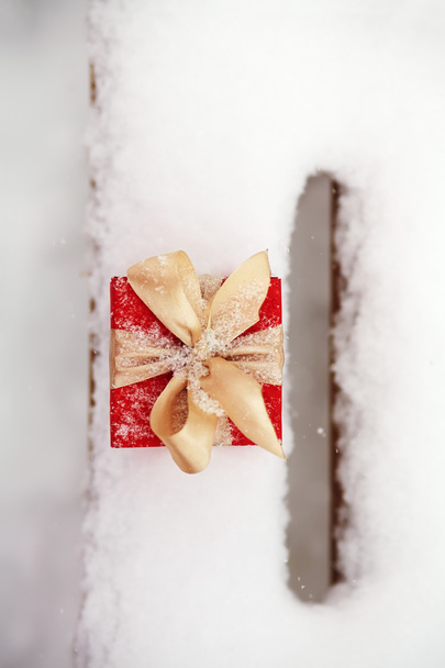 gift box in the snow outdoors - Fotó, kép