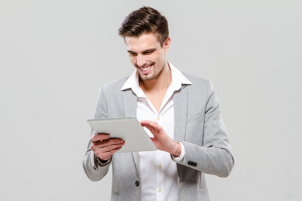 Happy young guy using tablet - Photo, image