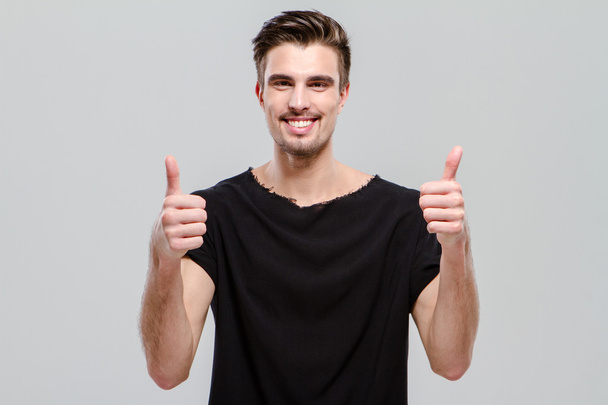 Happy confident man showing thumbs up - Fotó, kép