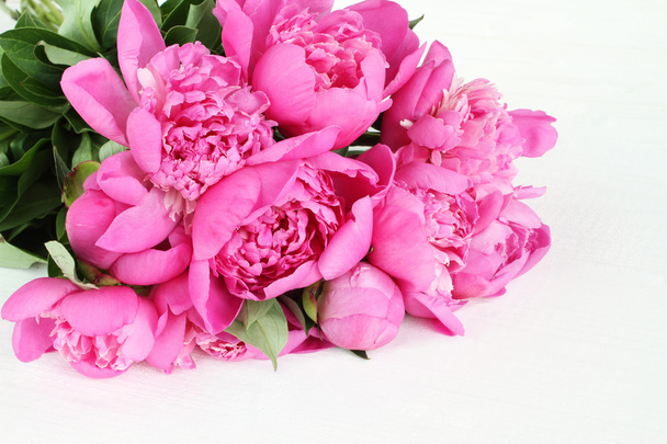 Bouquet of small pink peonies on white painted wooden background - Photo, Image