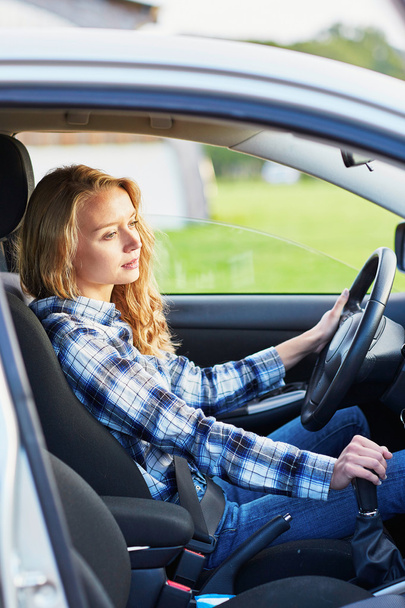 young woman driving a car - Фото, изображение