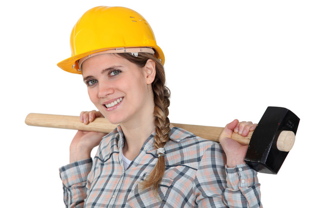 Woman holding sledge-hammer over shoulder - Fotografie, Obrázek