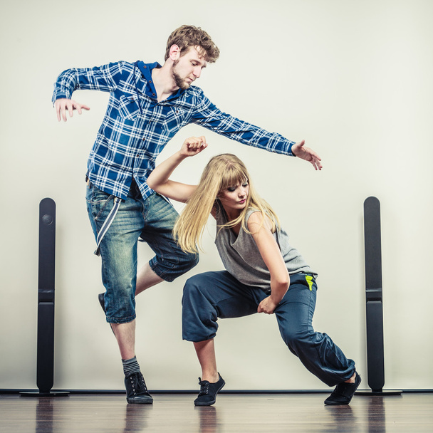 couple of young man and woman dancing hip-hop - Photo, image