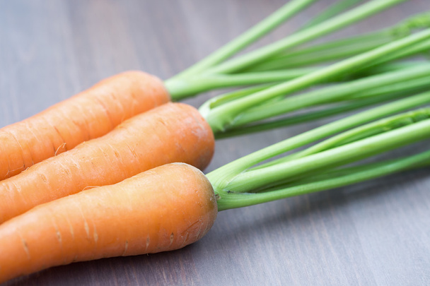 Raw carrots with green tops - Fotografie, Obrázek